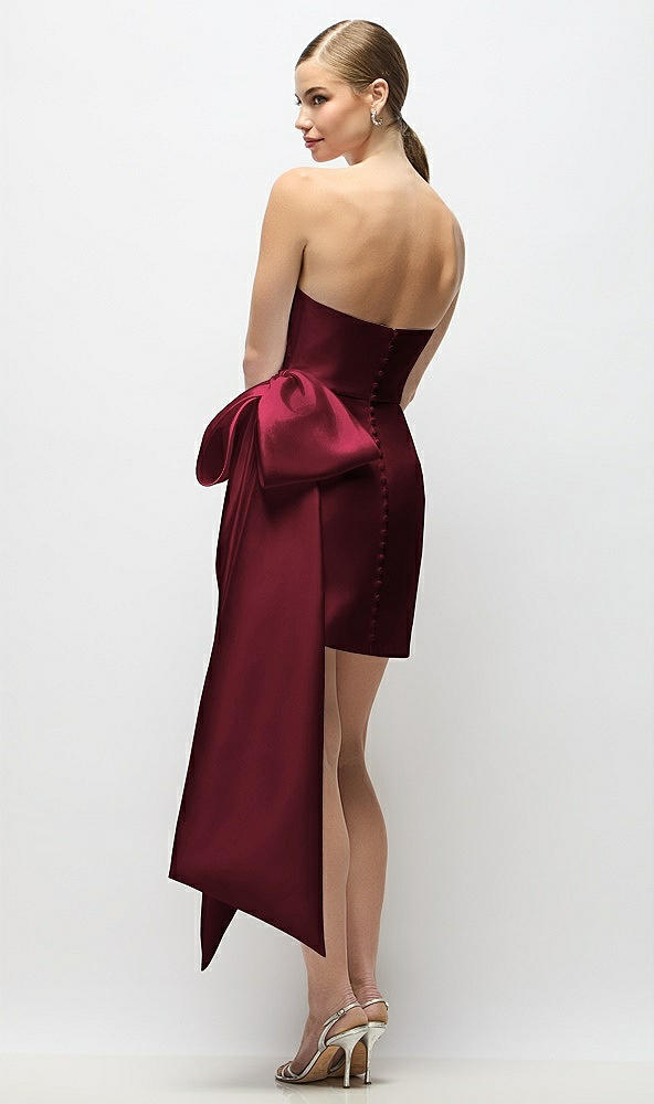 Back View - Cabernet Strapless Pleated Draped Satin Mini Dress with Dramatic Long Tail Bow & Covered Buttons
